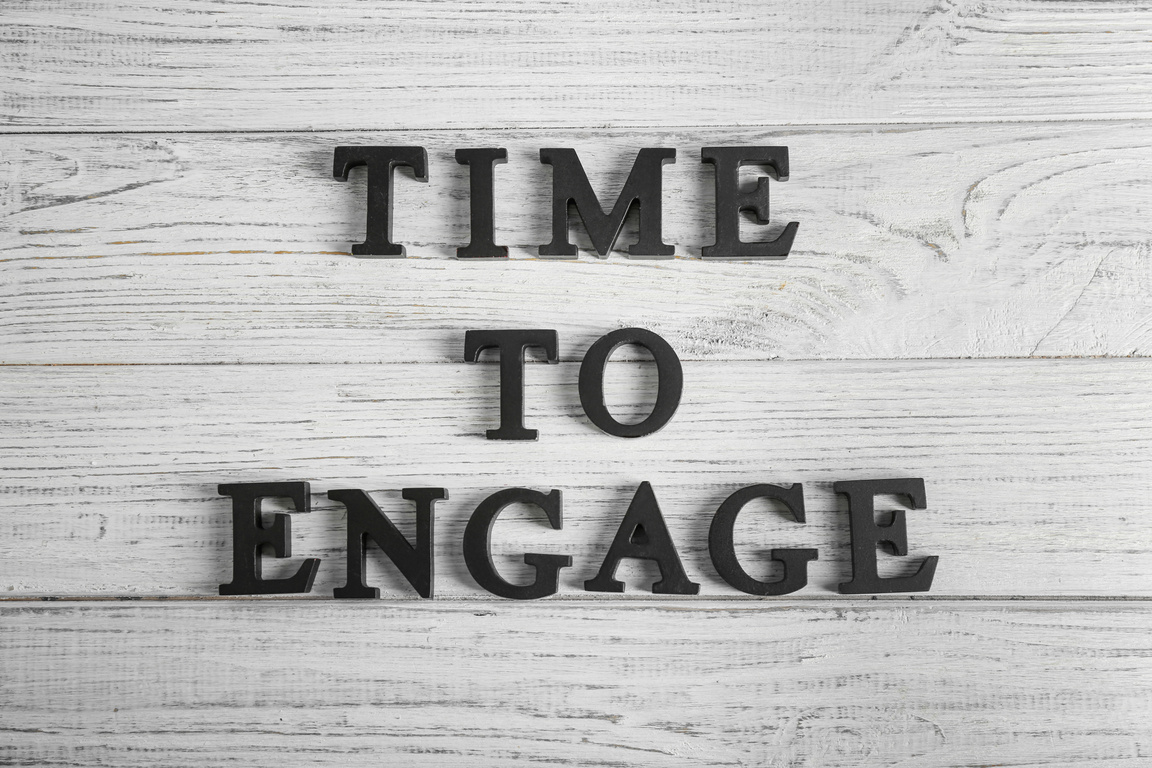 Phrase TIME to ENGAGE on Wooden Background